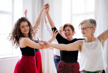 adobestock 291519681 halfpoint group of senior people in dancing class with dance teacher